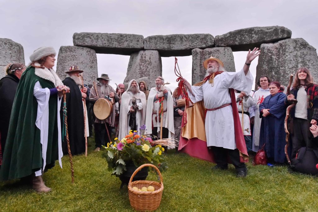 a group of druids celebrating at stonehenge