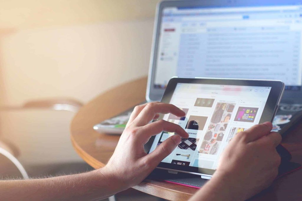 hand holding an ipad browsing the internet