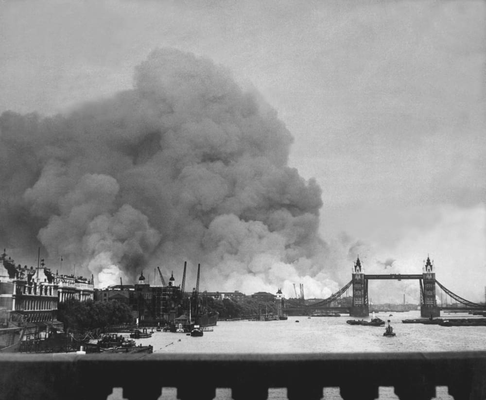 view from london bridge of the city on fire after a bombing raid